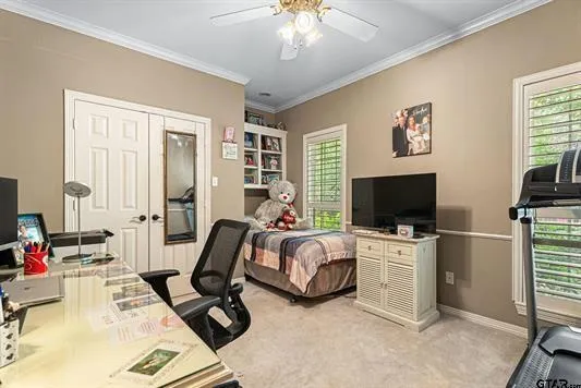 a view of a livingroom with workspace and a flat screen tv