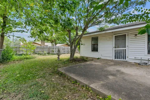 a view of a house with yard and a tree