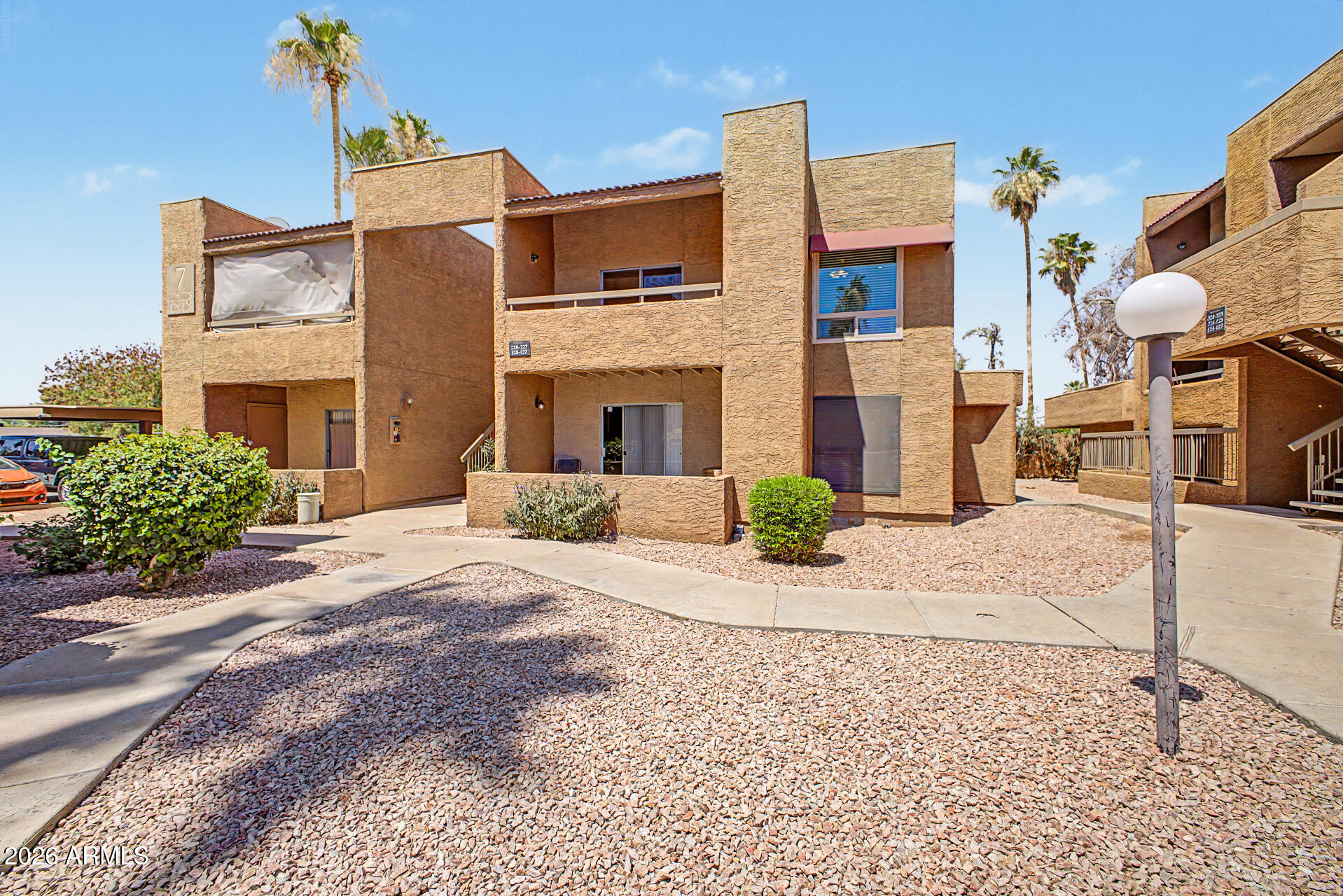 2625 East Indian School Road, Unit 227 Phoenix, AZ 85016 - Photo 1 of 31 a front view of a building with a garden