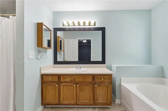 a bathroom with a sink a vanity and a mirror