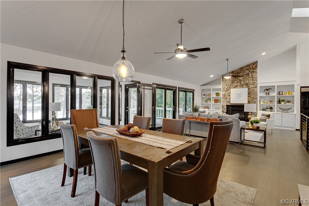 5623 Promontory Pointe Road Midlothian, VA 23112 - Photo 11 of 50 Dining area with a stone fireplace, built in shelv