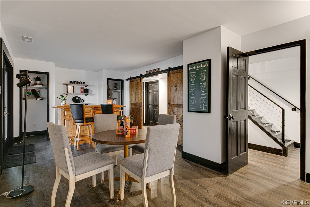 5623 Promontory Pointe Road Midlothian, VA 23112 - Photo 38 of 50 Dining room featuring a barn door and wood-type fl