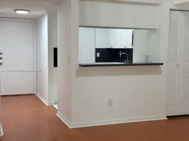 a view of microwave and cabinets