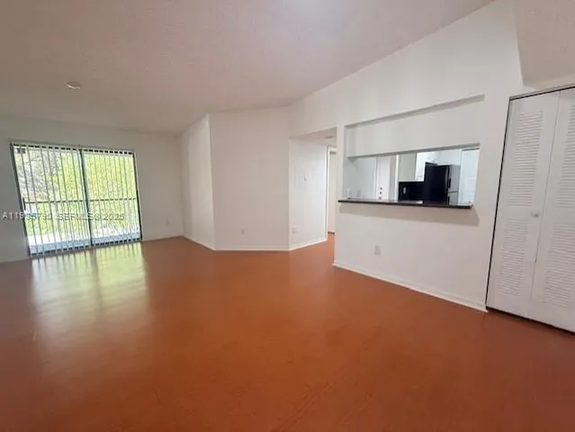 a view of a kitchen with a dishwasher cabinets and a wooden floor