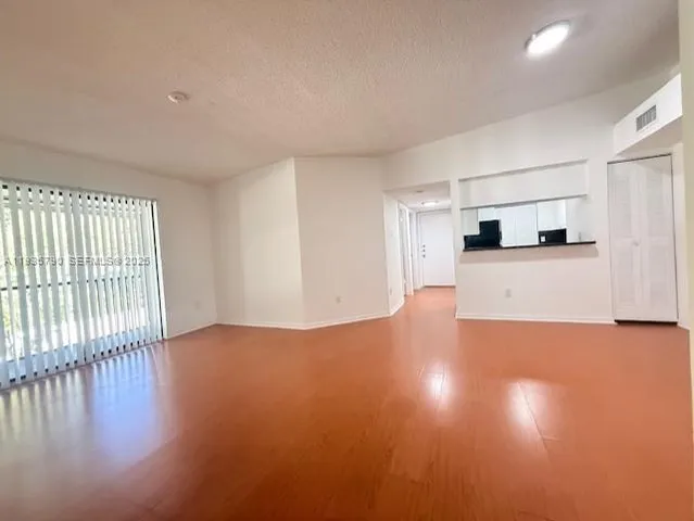 a view of a kitchen with a sink and a large window