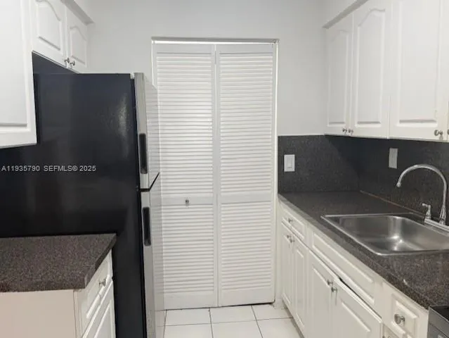 a kitchen with a sink and a refrigerator