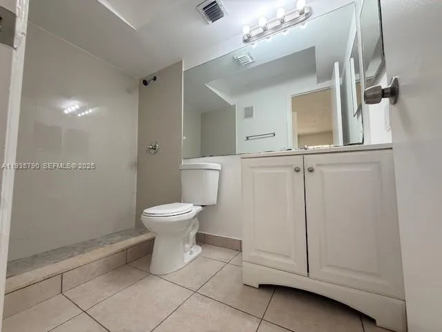 a bathroom with a toilet sink and shower