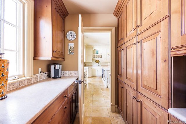 a kitchen with stainless steel appliances granite countertop a sink and a refrigerator