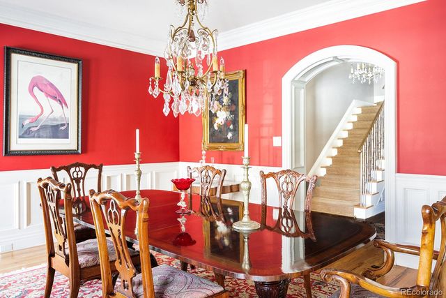 a view of a dining room with furniture and a chandelier