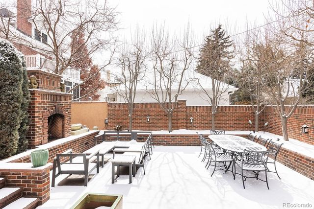 a view of a patio with a table and chairs