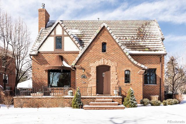 a view of a brick house with many windows