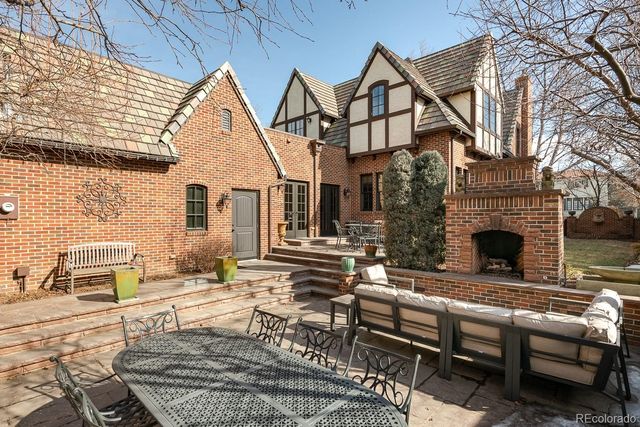 a view of a house with couches chairs and a table