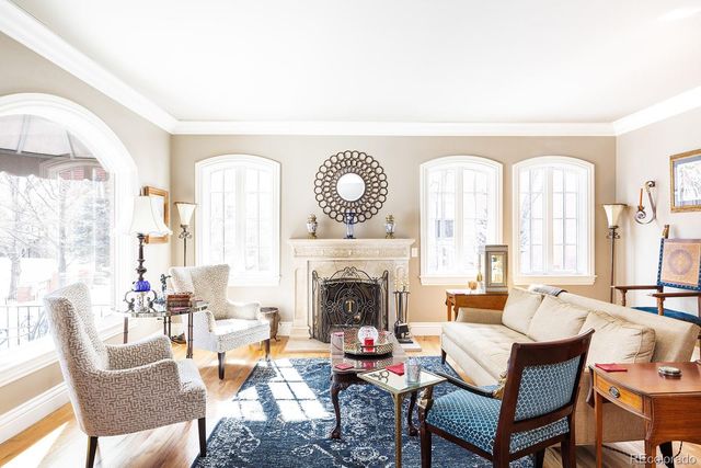 a living room with furniture a fireplace and a large window