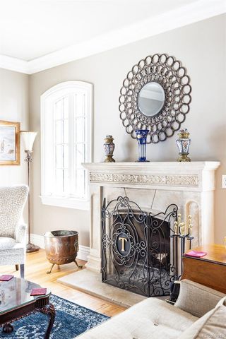 a living room with fireplace furniture and a wooden floor