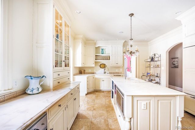 a large kitchen with a lot of counter space and wooden floor