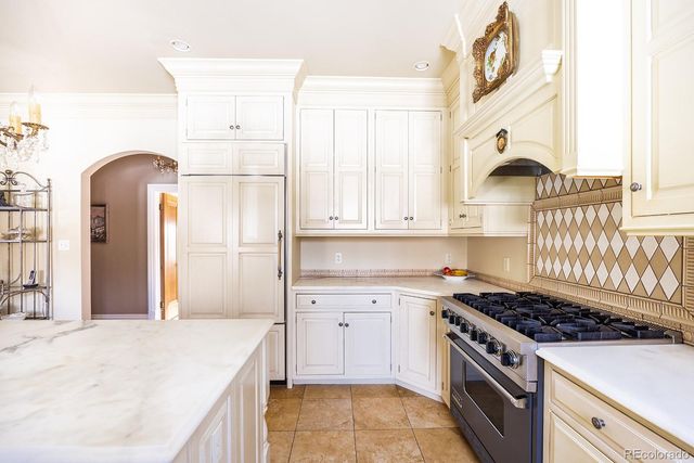 a kitchen with a stove a sink and a refrigerator