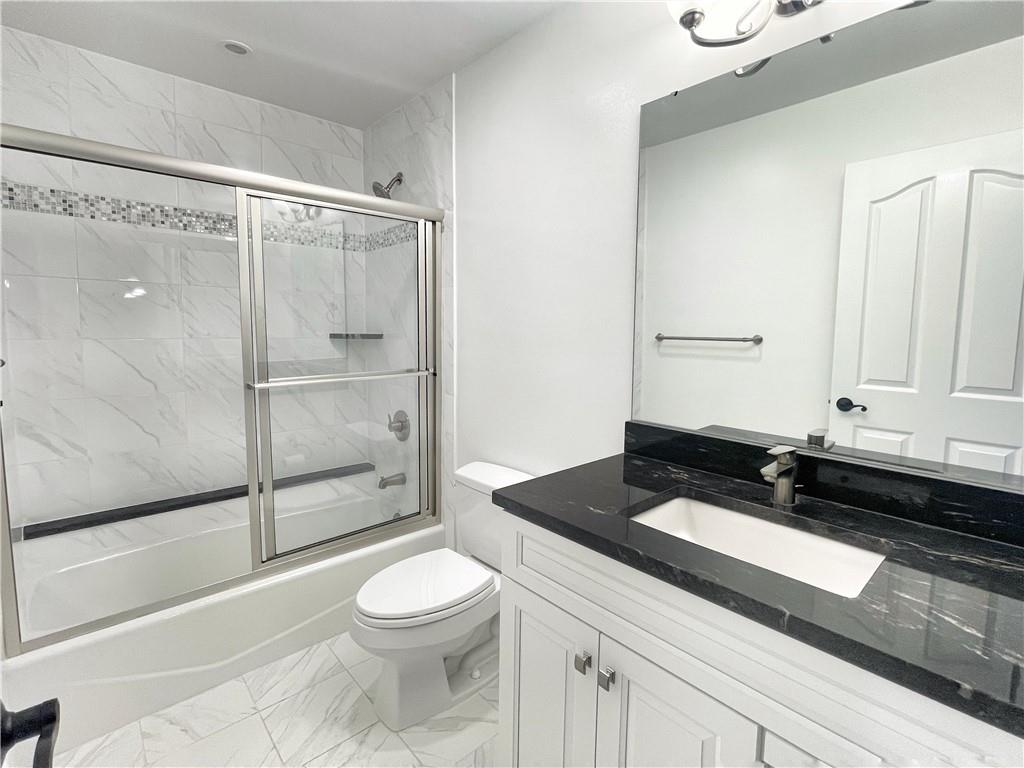 207 Adams Pointe Boulevard, Unit 6 Mars, PA 16046 - Photo 16 of 22 a bathroom with a granite countertop sink toilet and shower