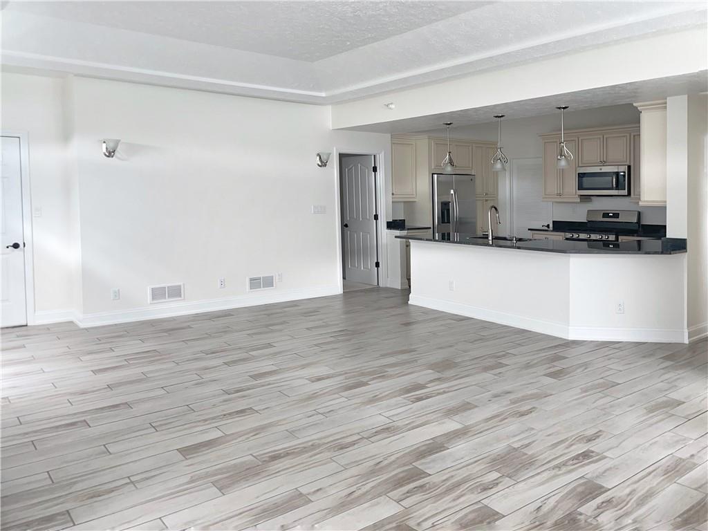 207 Adams Pointe Boulevard, Unit 6 Mars, PA 16046 - Photo 4 of 22 a view of kitchen with wooden floor and electronic appliances