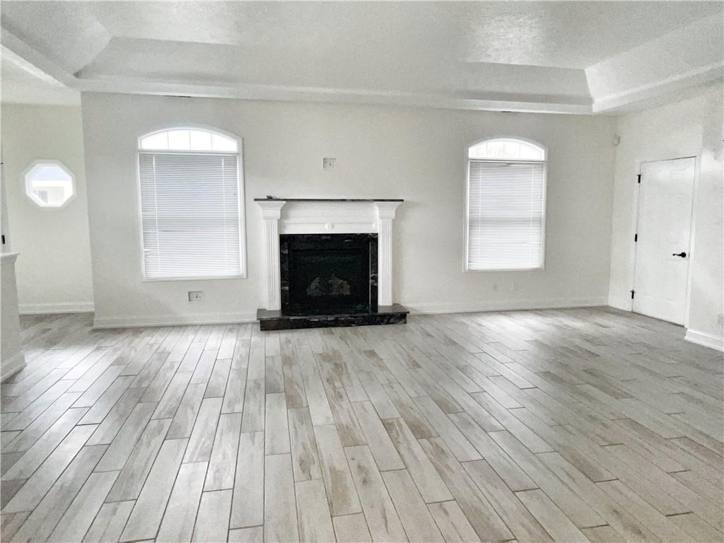 207 Adams Pointe Boulevard, Unit 6 Mars, PA 16046 - Photo 5 of 22 an empty room with wooden floor fireplace and windows