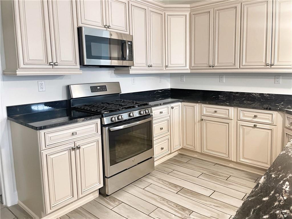 207 Adams Pointe Boulevard, Unit 6 Mars, PA 16046 - Photo 8 of 22 a kitchen with stainless steel appliances granite countertop grey cabinets a stove a sink and dishwasher