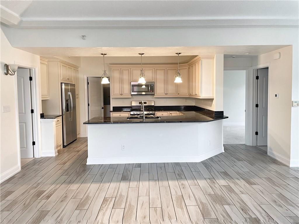 207 Adams Pointe Boulevard, Unit 6 Mars, PA 16046 - Photo 9 of 22 a view of kitchen with stainless steel appliances wooden floor and large window