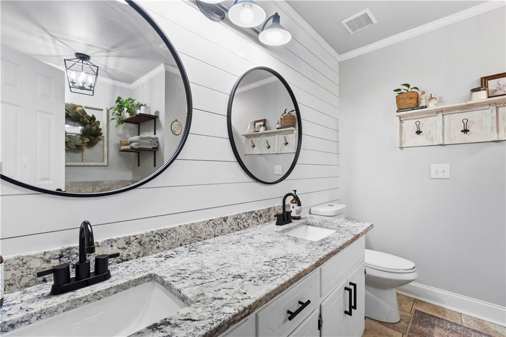 2777 Chickadee Drive Monroe, GA 30655 - Photo 14 of 36 a bathroom with a toilet a sink and a mirror
