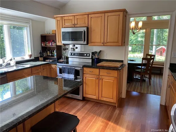 a kitchen with wooden floors and a sink