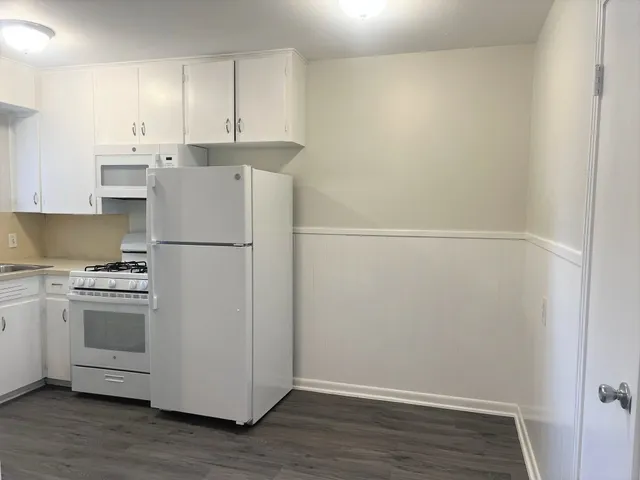 a kitchen with cabinets and stainless steel appliances
