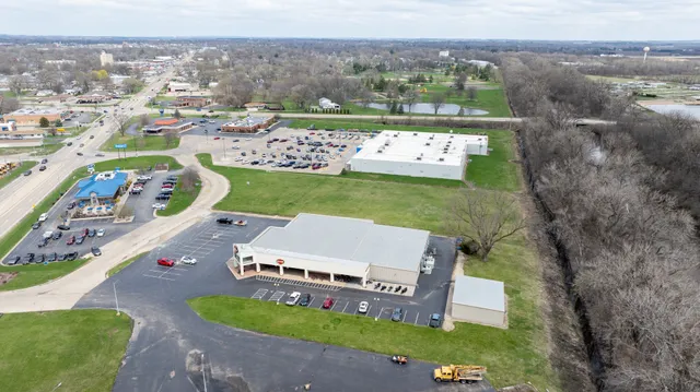 an aerial view of a house with a garden and mountains
