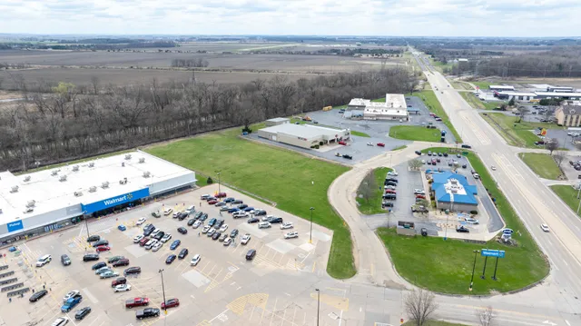 an aerial view of a swimming pool with a yard
