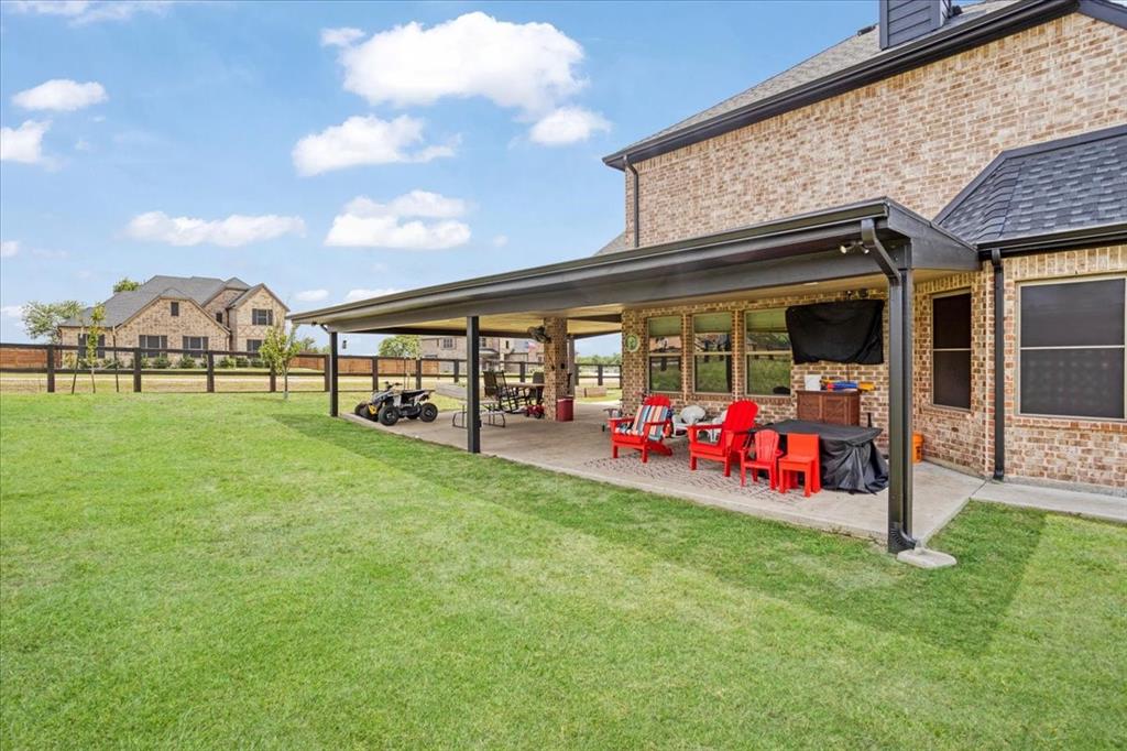 1205 Redbud Street Howe, TX 75459 - Photo 30 of 40 a view of a backyard with a garden and entertaining space