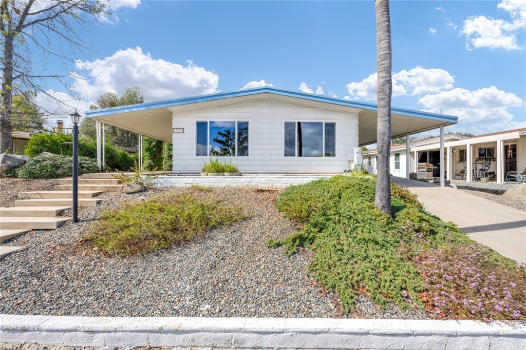 33733 Plowshare Road Wildomar, CA 92595 - Photo 2 of 38 a front view of a house with a yard and potted plants