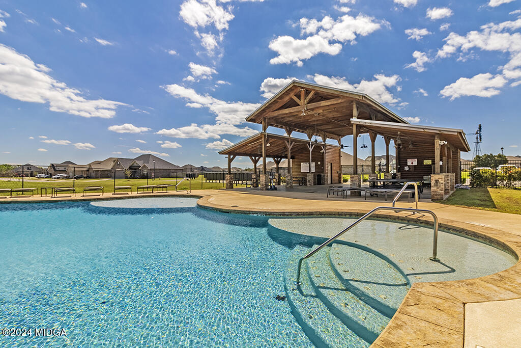 106 Cornfield Circle, Unit 57 Perry, GA 31069 - Photo 15 of 18 a view of a swimming pool with outdoor seating and deck