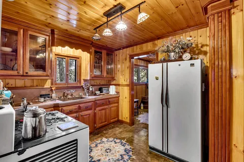 a kitchen with stainless steel appliances granite countertop a refrigerator and a sink