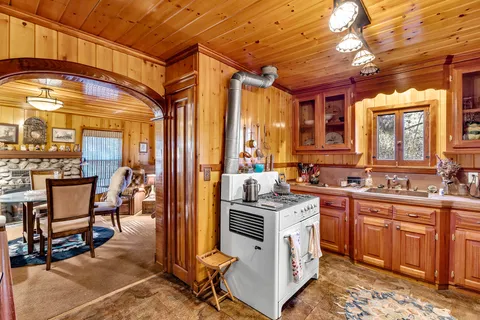 a kitchen that has a lot of cabinets in it and wooden cabinets