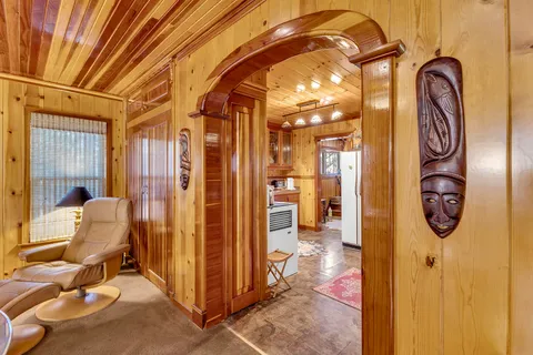 a view of a hallway with entryway dining area and chandelier