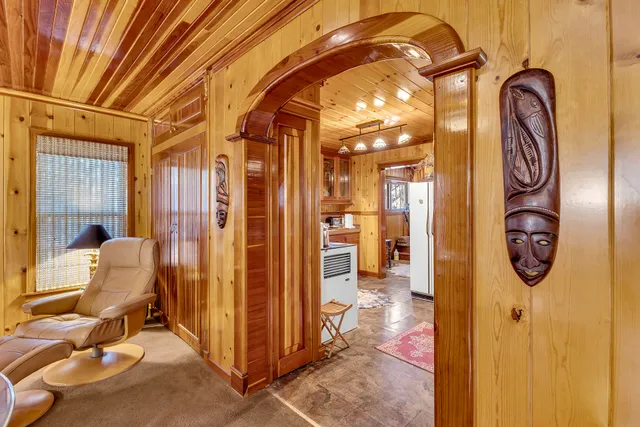 a view of a hallway with entryway dining area and chandelier
