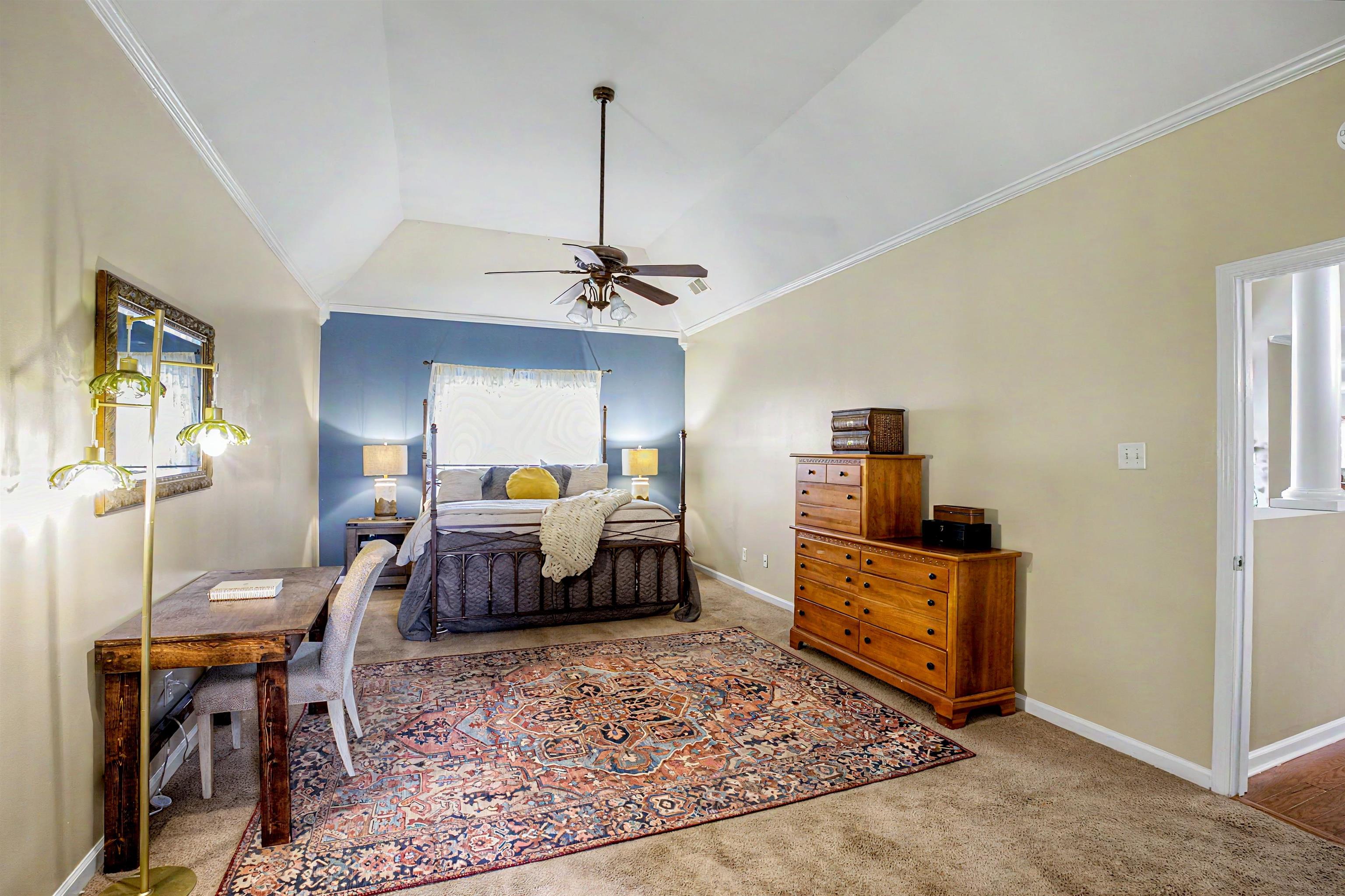 134 Rembert Drive Atoka, TN 38004 - Photo 23 of 38 Vaulted ceiling room featuring a blue accent wall and neutral toned walls
