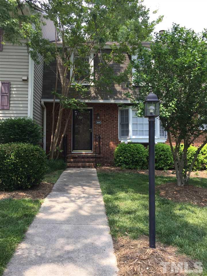 1034 Randolph Court Cary, NC 27511 - Photo 1 of 14 a front view of a house with garden