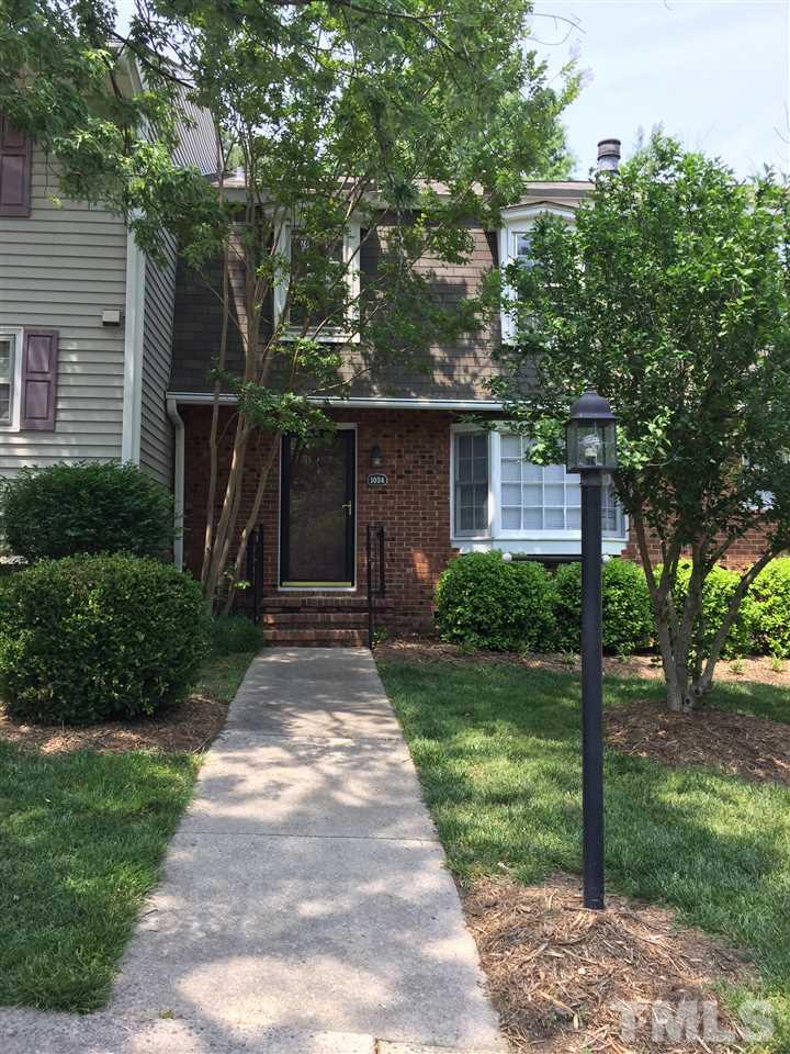 1034 Randolph Court Cary, NC 27511 - Photo 2 of 14 a front view of a house with garden