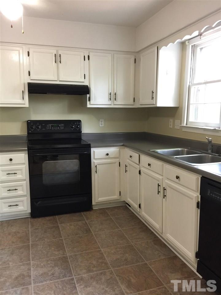 1034 Randolph Court Cary, NC 27511 - Photo 5 of 14 a kitchen with cabinets and window