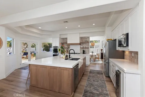 a large kitchen with stainless steel appliances granite countertop a large center island and a sink