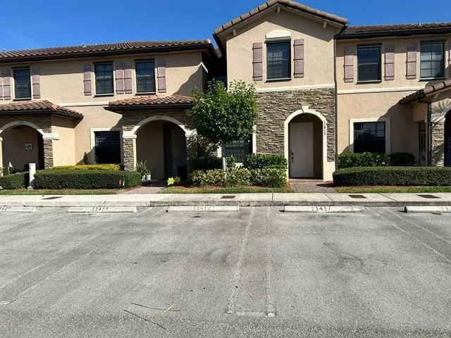 a view of house with yard and front view of house
