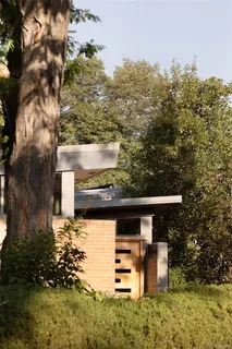 a view of a patio with table and chairs with wooden fence and plants