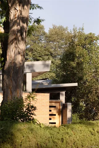 a view of a patio with table and chairs with wooden fence and plants