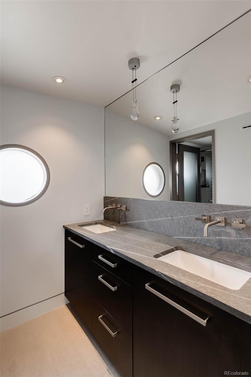 101 South Humboldt Street Denver, CO 80209 - Photo 38 of 50 a bathroom with a granite countertop sink a toilet and a mirror