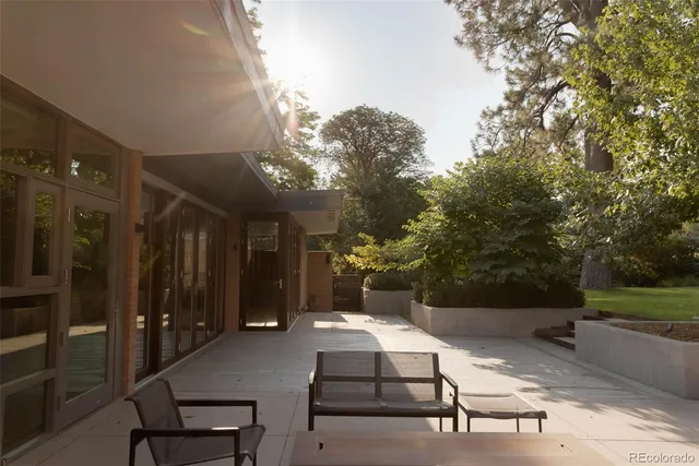 a living room with furniture a flat screen tv and a large window