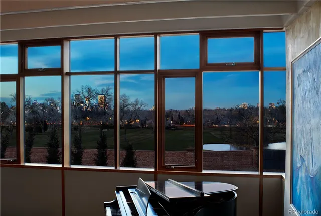 a bedroom with a large bed and a large window with outer view