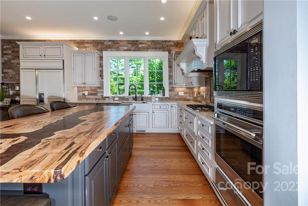 146 Allison Creek Trail Brevard, NC 28712 - Photo 11 of 48 a large kitchen with stainless steel appliances granite countertop a large counter top a stove and a sink