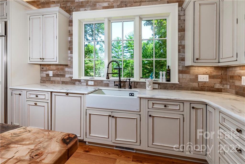 146 Allison Creek Trail Brevard, NC 28712 - Photo 14 of 48 a kitchen with white cabinets and window
